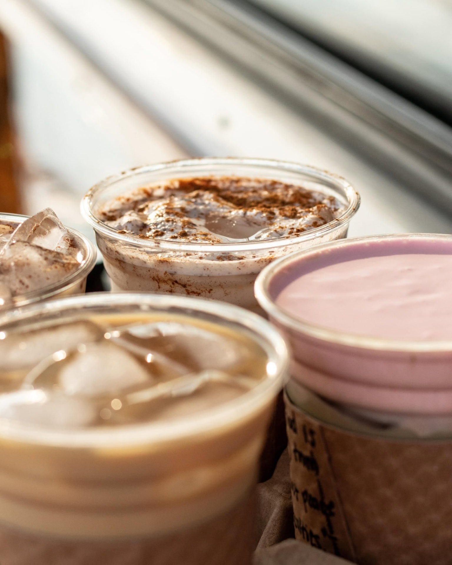 Iced drinks lined up in the sunlight on the trailer counter